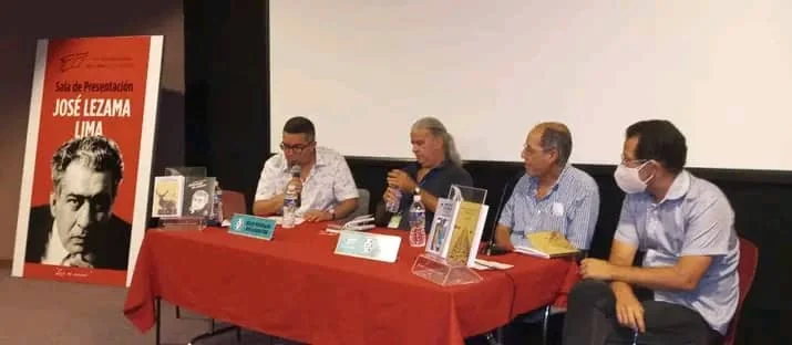 Launch table in the José Lezama Lima room, with four participants and the books on display