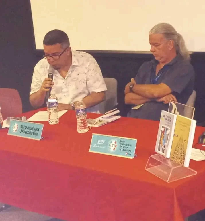 Two of the participants at the launch table, one of them at the microphone