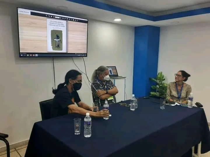 Launch table with the digital book projected on a screen behind